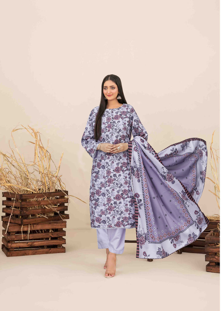 Woman in a floral dress with a flowing dupatta standing against a neutral background