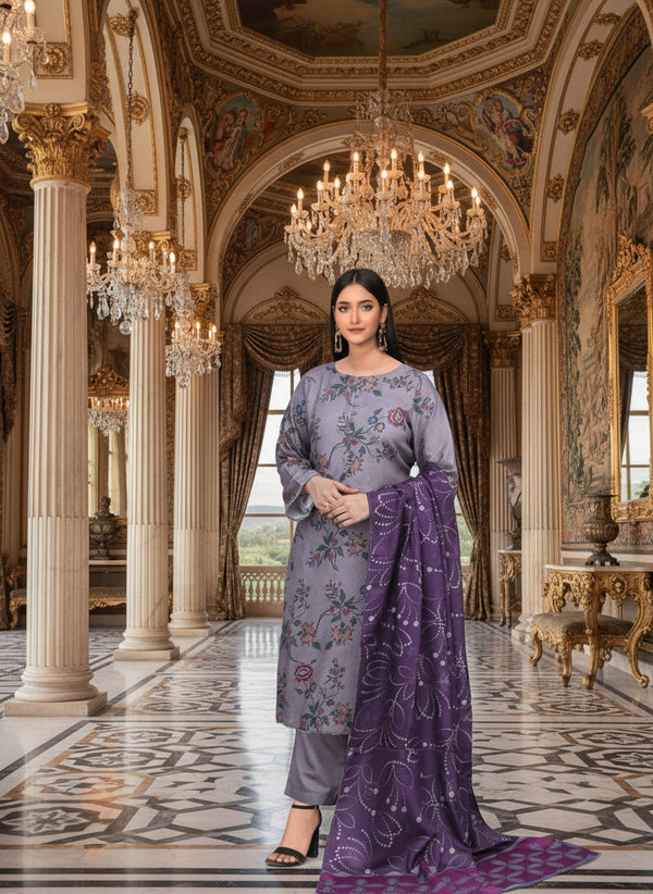 Woman in a gray floral dress with a purple dupatta standing in front of a decorative wall.